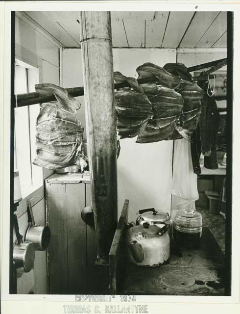 Salmon hanging to dry above a wood stove