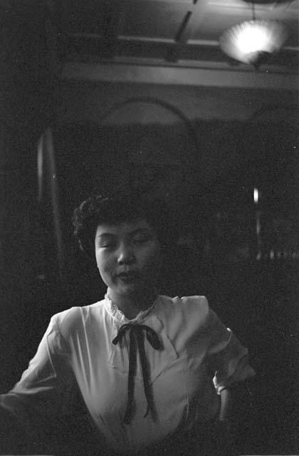 Woman with ribbon tie blouse.