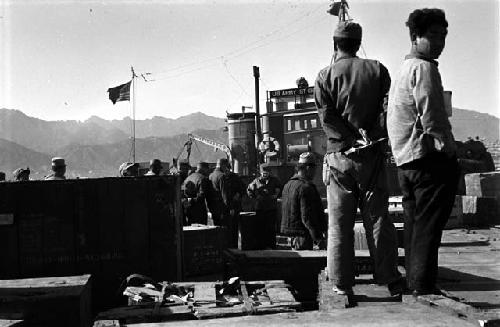 Military Men; One Civilian; Army Sign