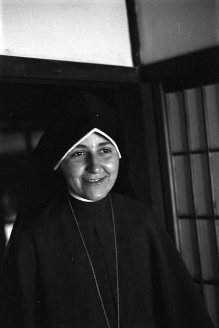 Nun in black habit smiling.