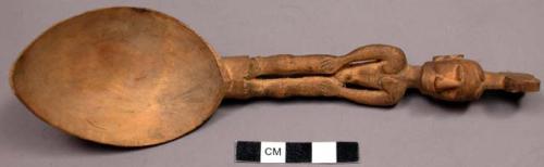 Spoon, carving represents a spaniard