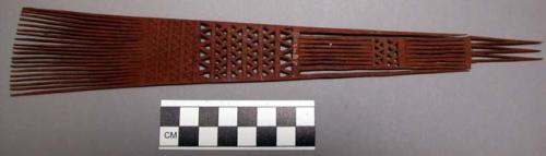 Comb, flaring tines, chip carved and openwork handle, broken end