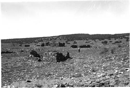 Man Standing Among Adobe Houses