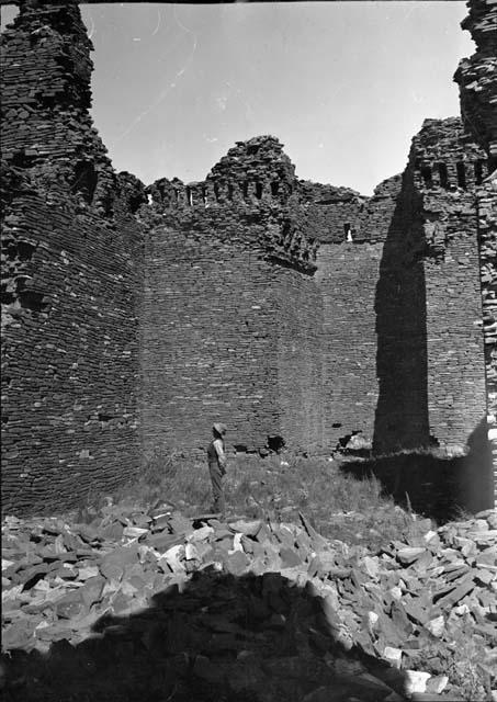 Man Standing Among Church Ruins