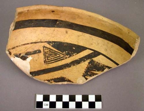 Fragments of black on yellow pottery bowl - restorable?