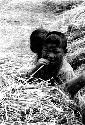 Children in hay; titled "People are still the same in China as anywhere else"