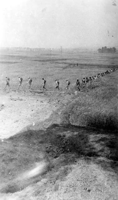 Soldiers marching; titled "Marching Chinese troops"