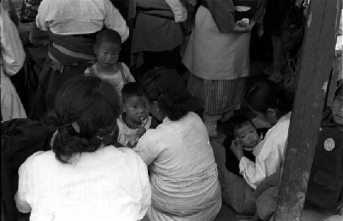 Children being held by women