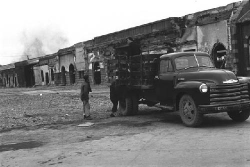 Men getting into the back of a pick-up truck.