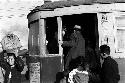 Man with children boarding trolley.