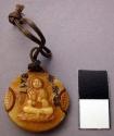 Good luck charm made of bone - on one side is sign of buddha, on other is sign o