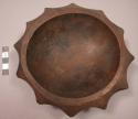 Carved, Carved, dark colored wooden bowl with scalloped edges, pierced for hangi