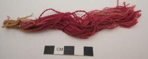 Organic, fiber bundle, twisted red fringe, tied with yellow string at one end