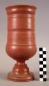 Ceramic, earthenware complete vessel, turned, pedestal base, cylindrical form, flared rim, red slipped exterior