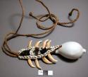 Breast ornament with shell pendant