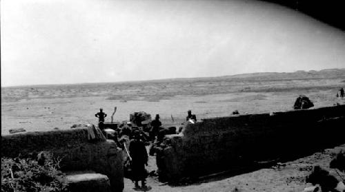 People standing by a wall