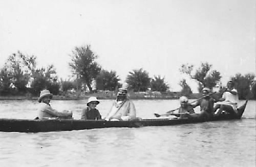 Close view of boat with Marsh Arab and western men