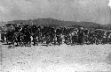 Chinese men pulling concrete cylinder with rope; titled "Rolling Airfield"