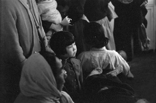 Child looking from crowd of people.