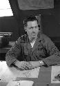 U.S. soldier Quinn at desk in army base office.