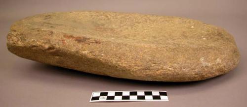 Metate. ovoid. open ended narrow shallow trough with only slight rim. ground gra