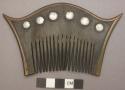 Man's comb-wood edged with brass; decorated on one side with 6 small metal discs