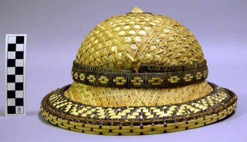 Woven hat, bowler style with wood finial