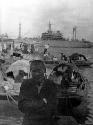 Man in front of boats and ship