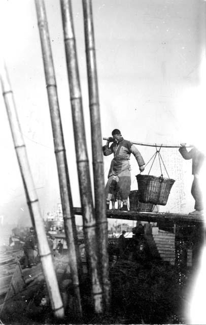 Men hauling basket of coal