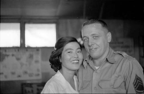 U.S. Soldier and Korean woman looking toward camera