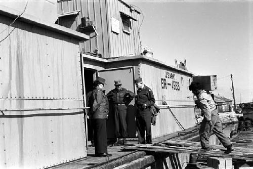 Soldiers carrying boxes and freight