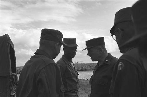 Military men meeting on beach