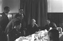 Men sitting at table in Dining Hall.