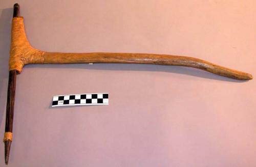 Axe, "instruments of warfare."  Held with point backwards and swung backwards