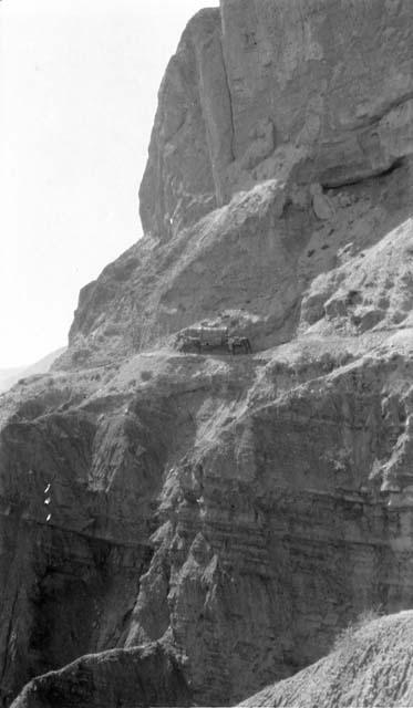 People with ponies climbing mountain path