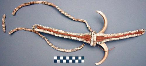Breast ornament of boar's tusks, long central piece edged with nasca +