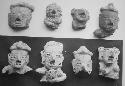 Figurine heads (8), ruddy paste, white slip