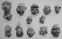 Figurine heads (12), red-brown, unslipped