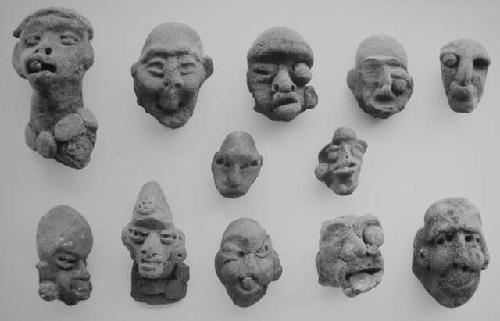 Figurine heads (12), red-brown, unslipped