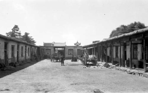 People and carts outside of buildings