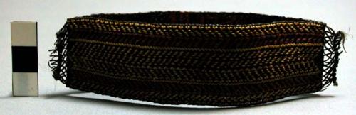 Fibre armband, red and yellow on black ("shemgwe"). Made by men.