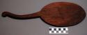 Large flat wooden spoon used to mix and stir papeda