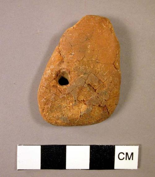 Roughly triangular pendant of weathered amber