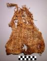 Woven cloth, loose plainweave, brown and white yarn, torn