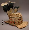 Dome shaped hat made of whole straws or reeds, with central hole in top, and fro
