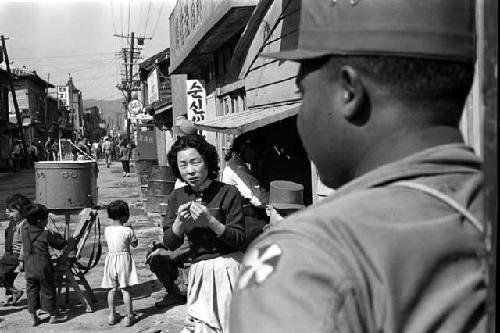 U.S. 8th Army soldier looking down the road nicknamed “Texas” Street, near the train station