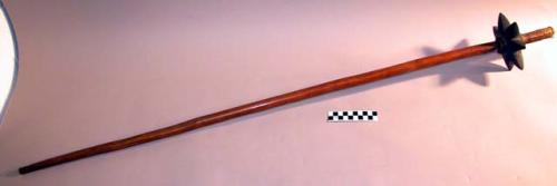 Club - wooden handle; head of black stone shaped like 7-pointed +