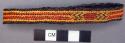 Basketry arm band - dark brown with red & yellow design