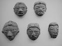 Figurine heads (8), red-brown, except #7, black, polished.