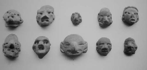 Figurine heads (8), red-brown, unslipped